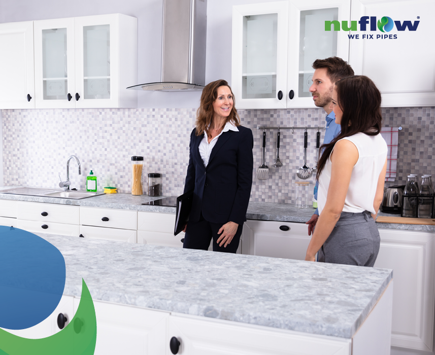 Real estate agent showing kitchen to young couple